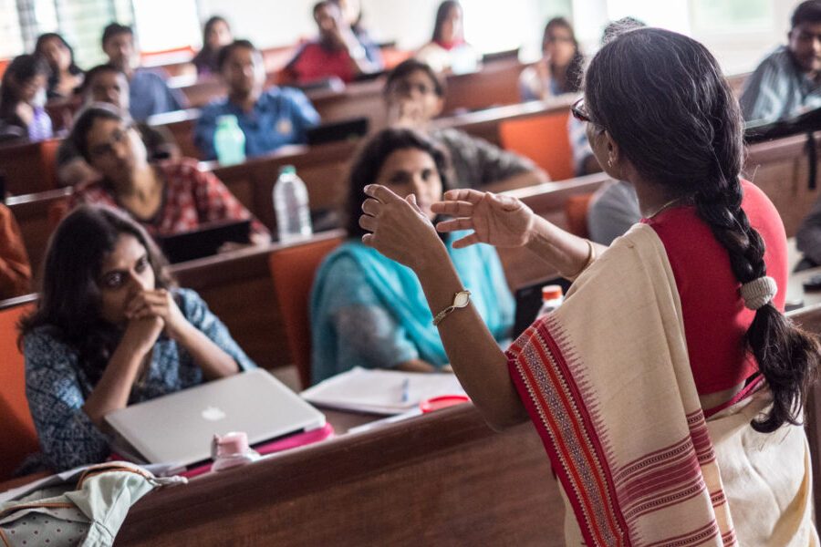 A professor at Azim Premji University, in Bangalore, India, lectures to a classroom full of students.